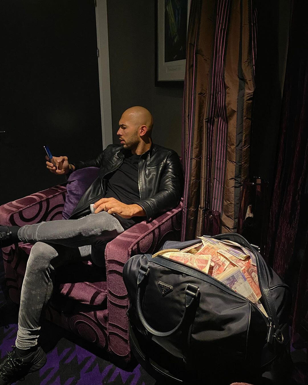 Andrew Tate with a bag of cash